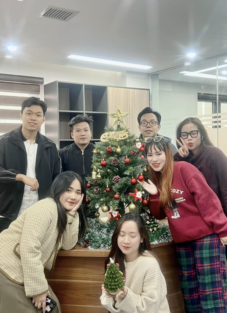 Ha Noi office's staff taking picture with the Christmas tree